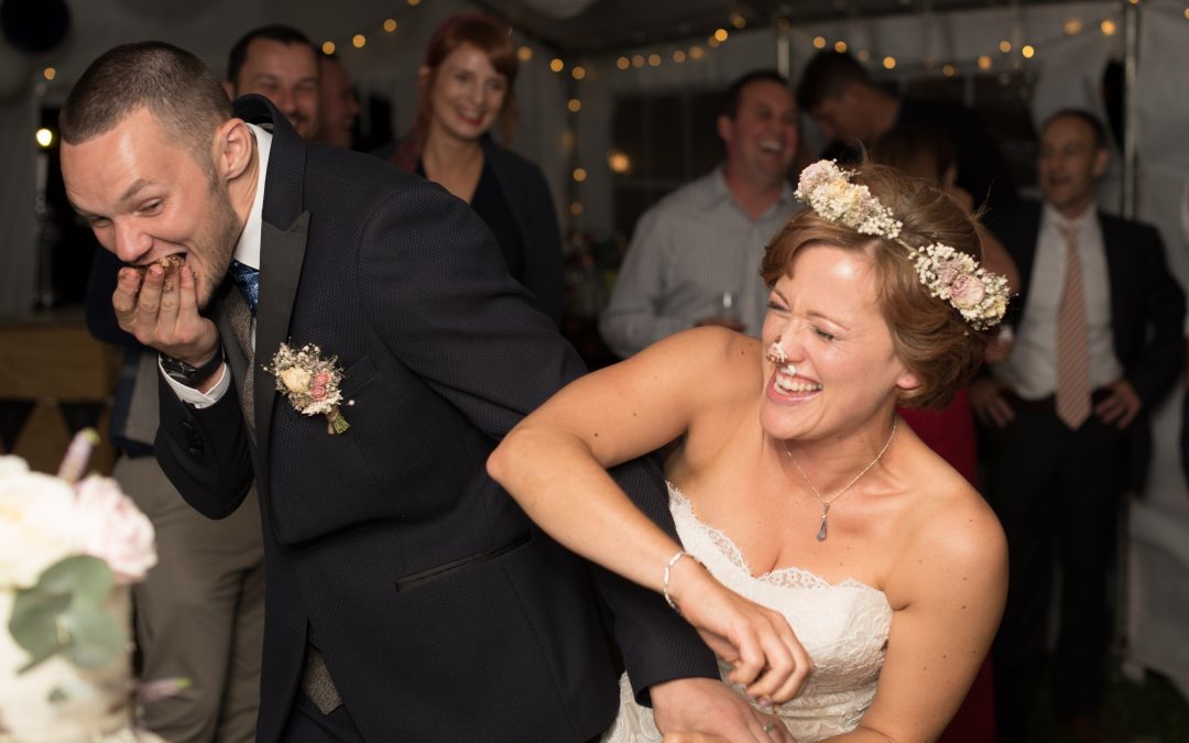 Lucy and Dan bride and groom cutting cake