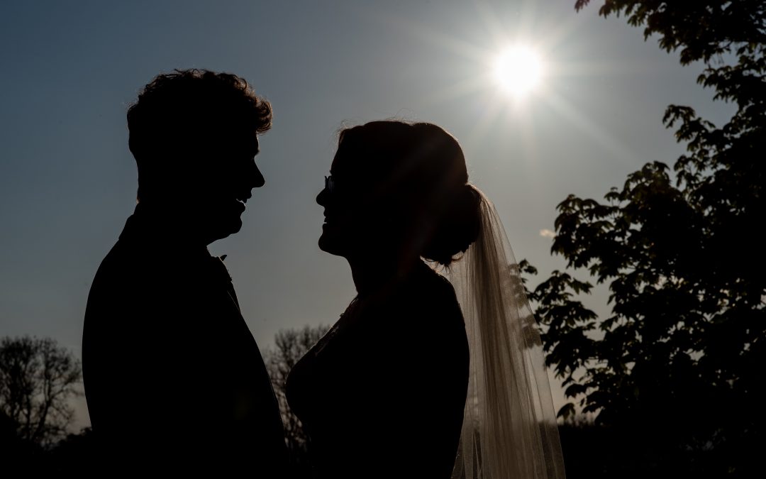 bride and groom portrait backlit