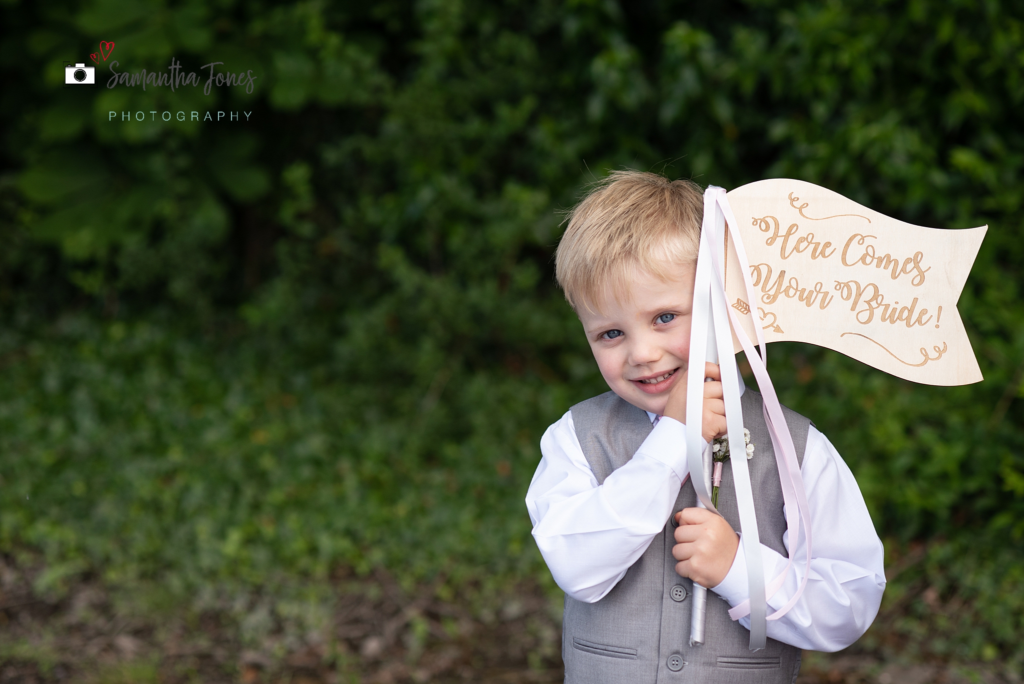 cute page boy holding flag wedding at Stonelees Golf Centre