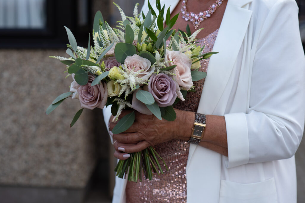 bride with her wedding bouquet of pink roses